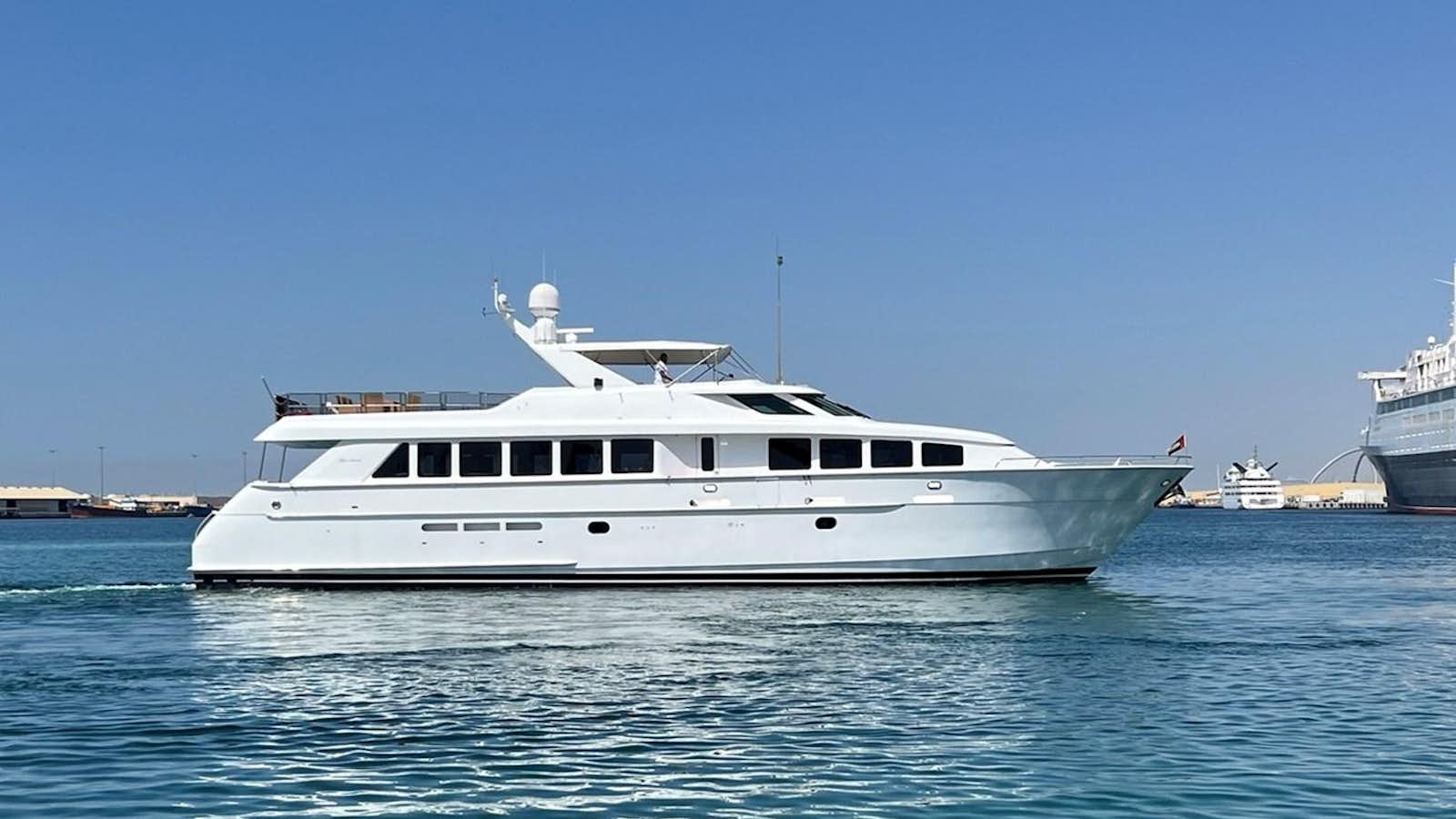 a white yacht in the water aboard 1998 HATTERAS 92 Yacht for Sale