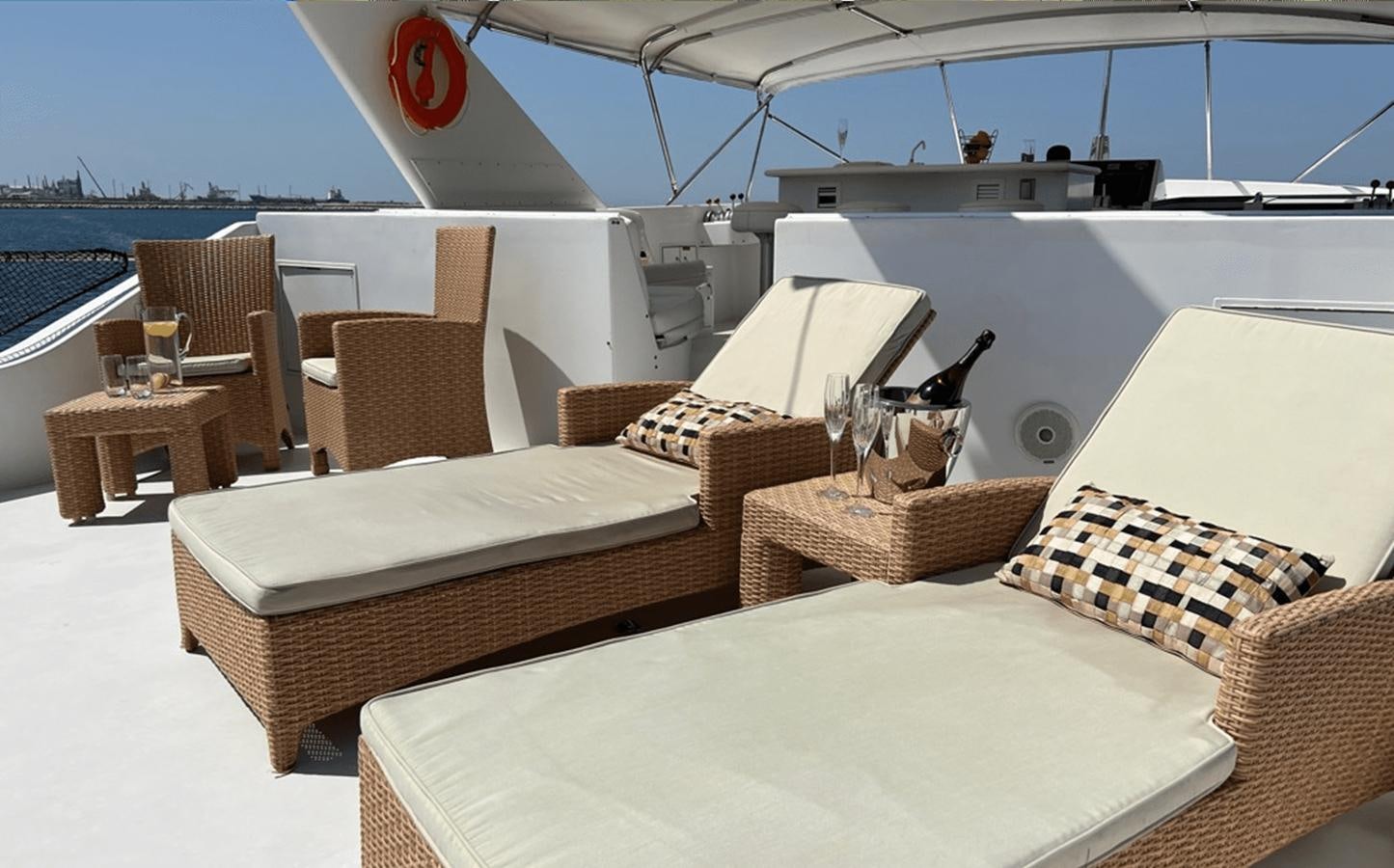 a boat with a bed and chairs aboard 1998 HATTERAS 92 Yacht for Sale