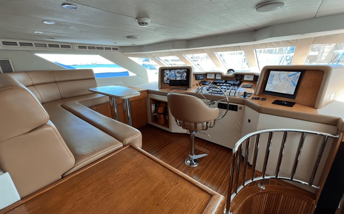 a room with a couch and chairs aboard 1998 HATTERAS 92 Yacht for Sale
