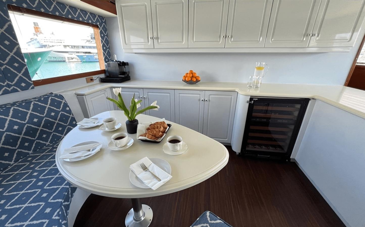a kitchen with white cabinets aboard 1998 HATTERAS 92 Yacht for Sale