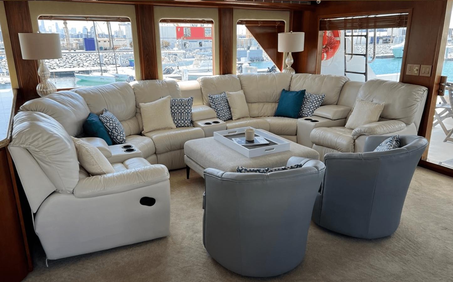 a living room with a couch and a coffee table aboard 1998 HATTERAS 92 Yacht for Sale