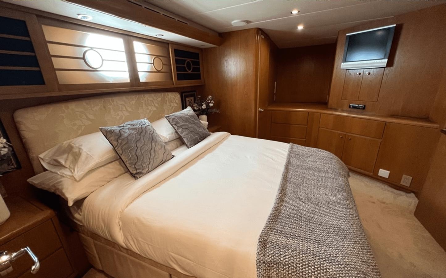 a bed in a room aboard 1998 HATTERAS 92 Yacht for Sale