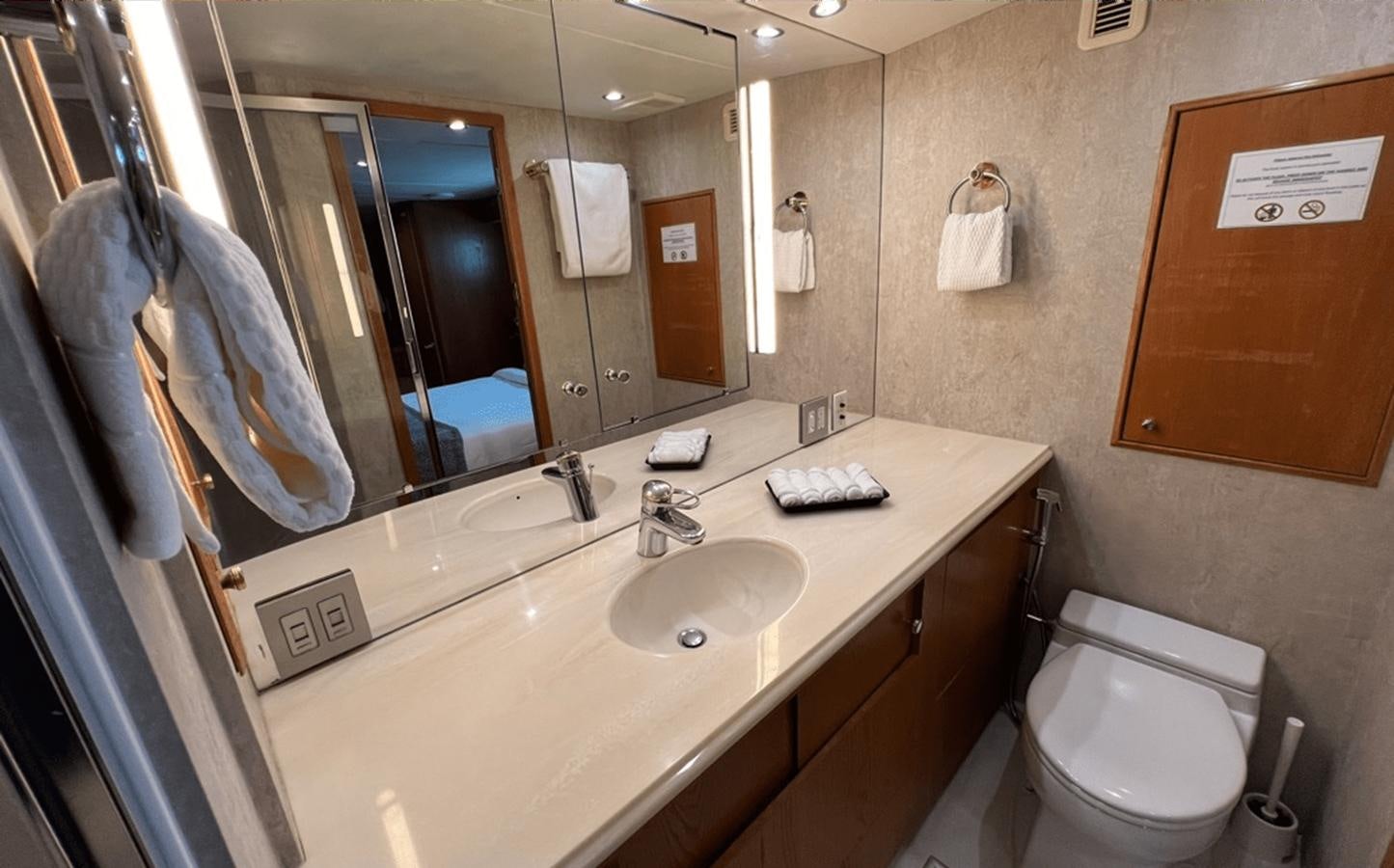 a bathroom with a sink and a mirror aboard 1998 HATTERAS 92 Yacht for Sale