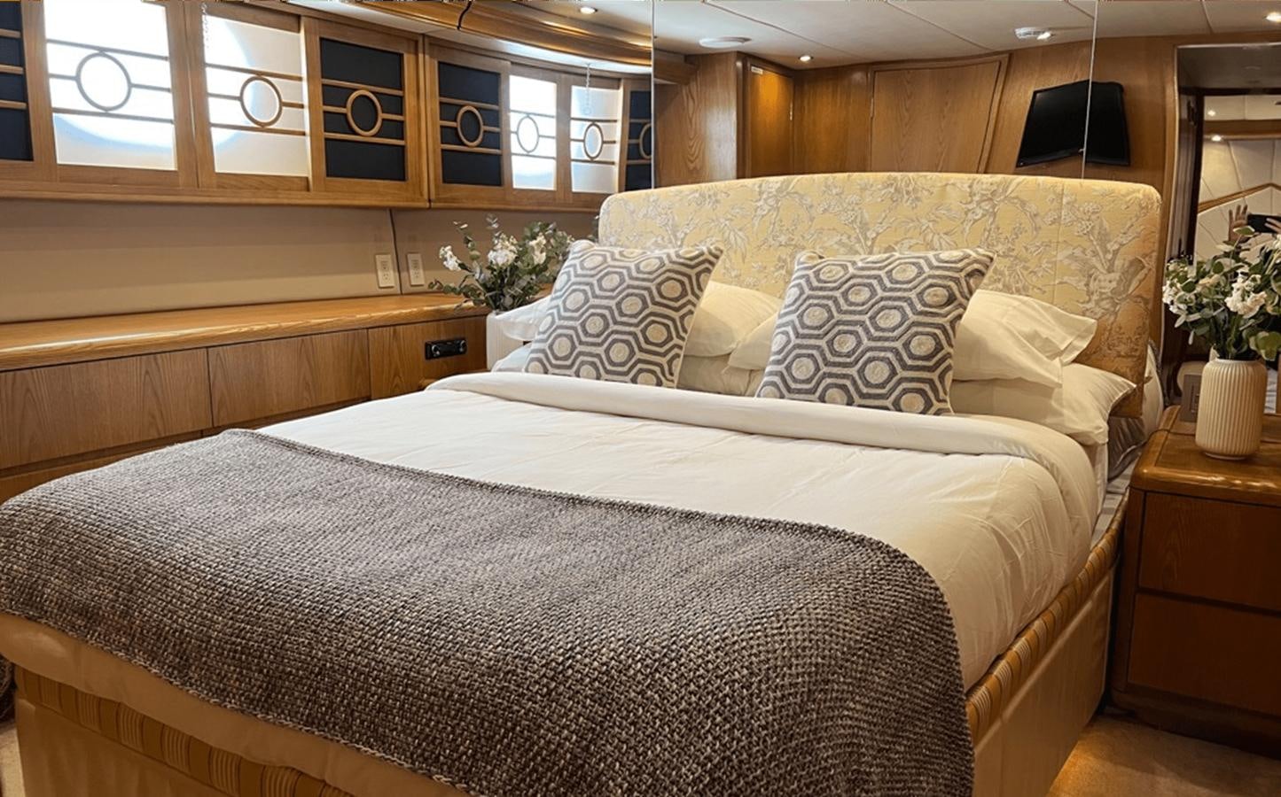 a bed with white sheets aboard 1998 HATTERAS 92 Yacht for Sale