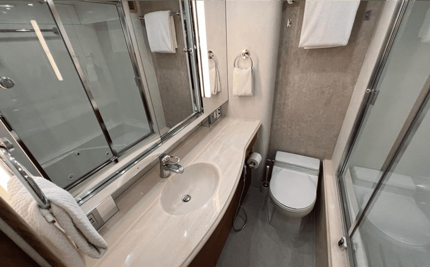 a bathroom with a sink and toilet aboard 1998 HATTERAS 92 Yacht for Sale