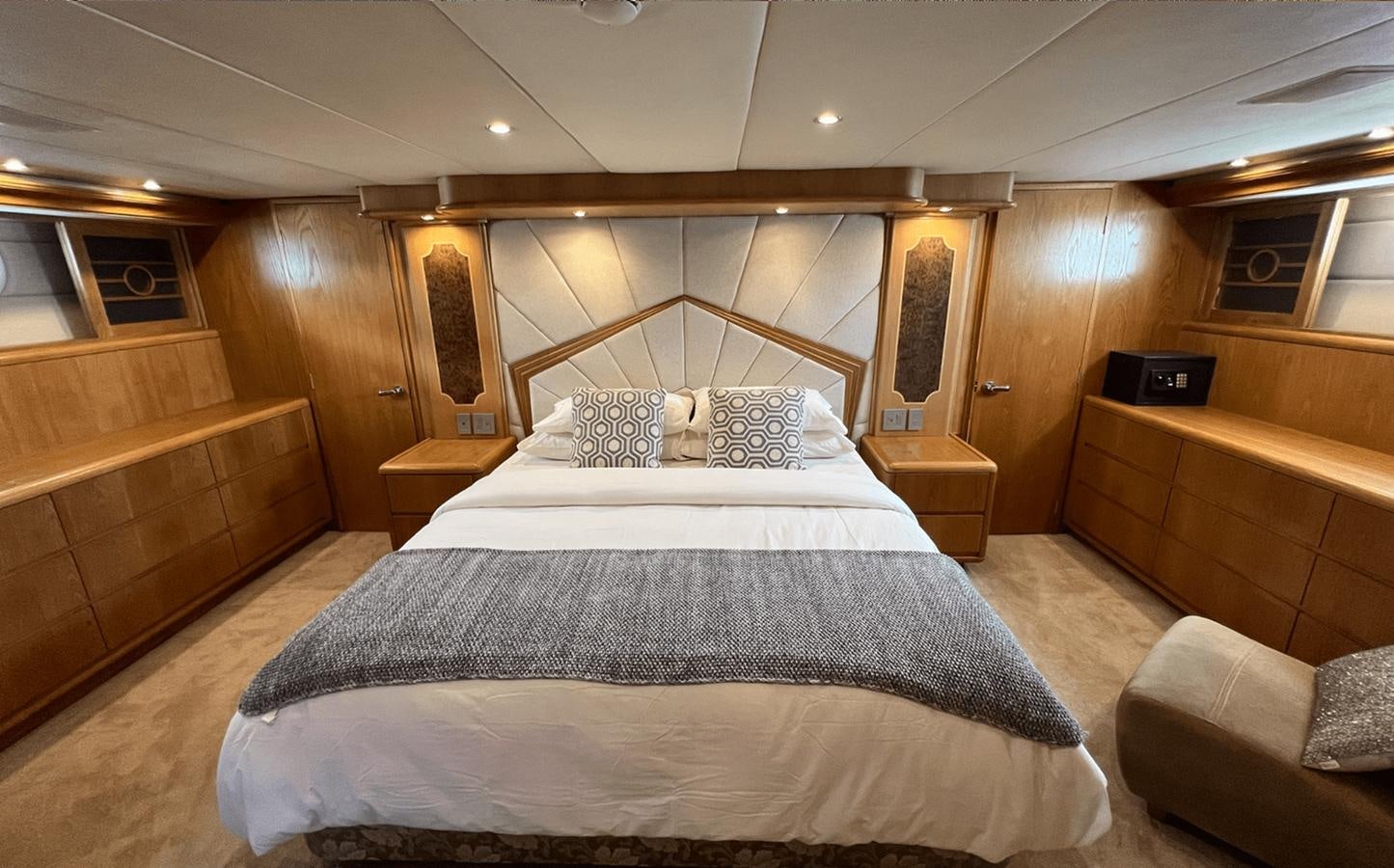 a large bed in a room aboard 1998 HATTERAS 92 Yacht for Sale
