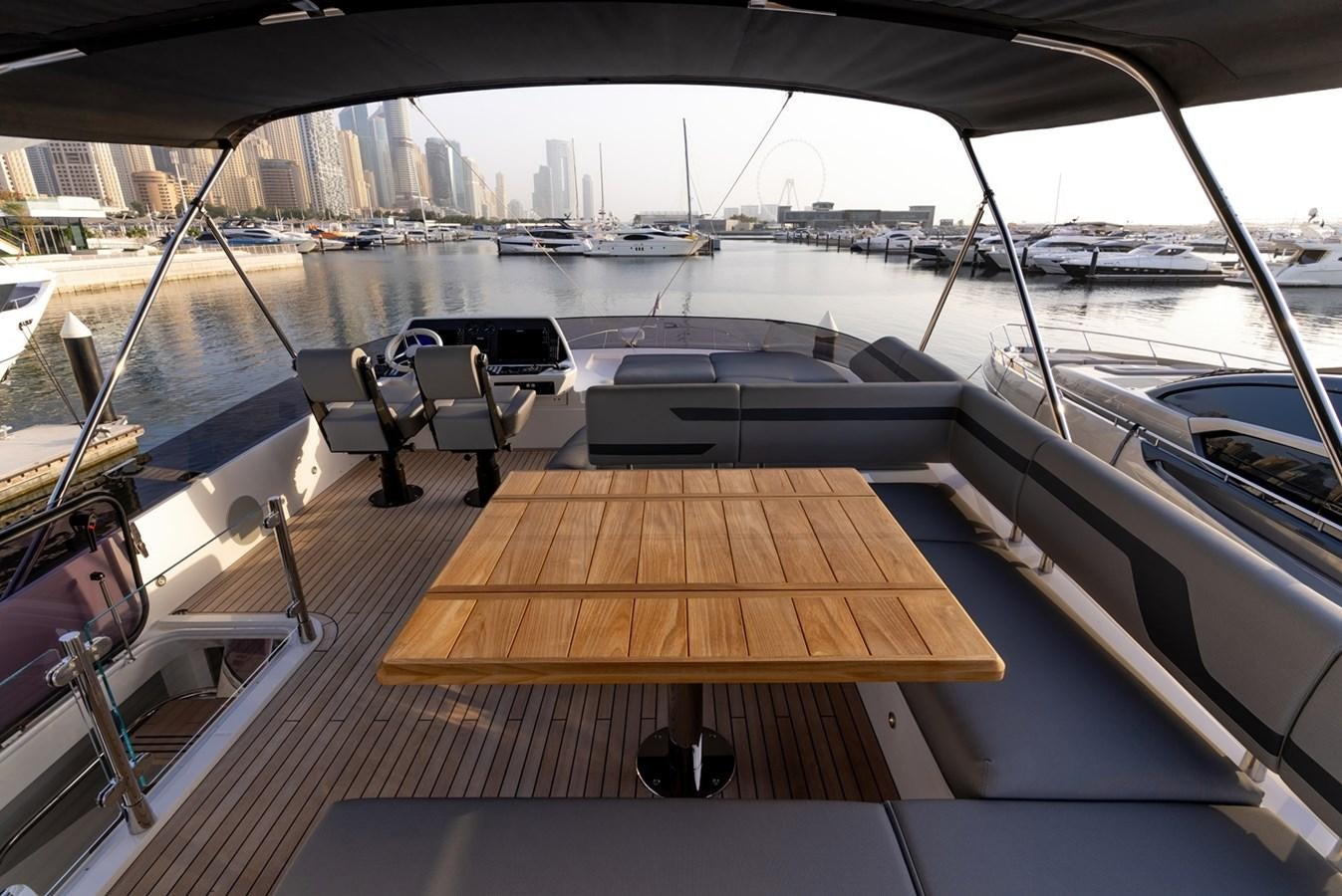 a deck with a view of a city and water aboard 2023 SUNSEEKER 74 SPORTS  XPS Yacht for Sale
