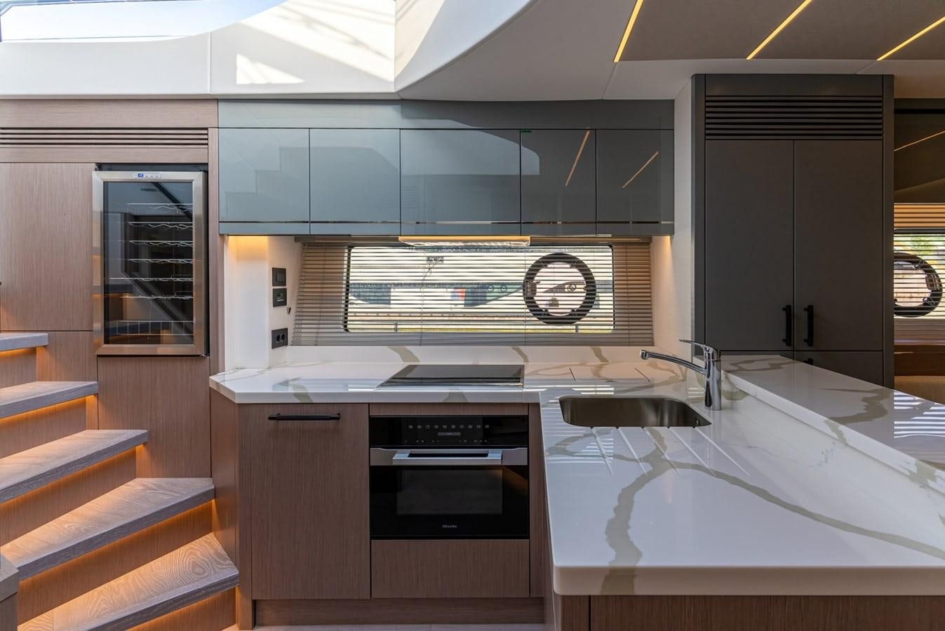 a kitchen with a stove and a sink aboard 2023 SUNSEEKER 74 SPORTS  XPS Yacht for Sale
