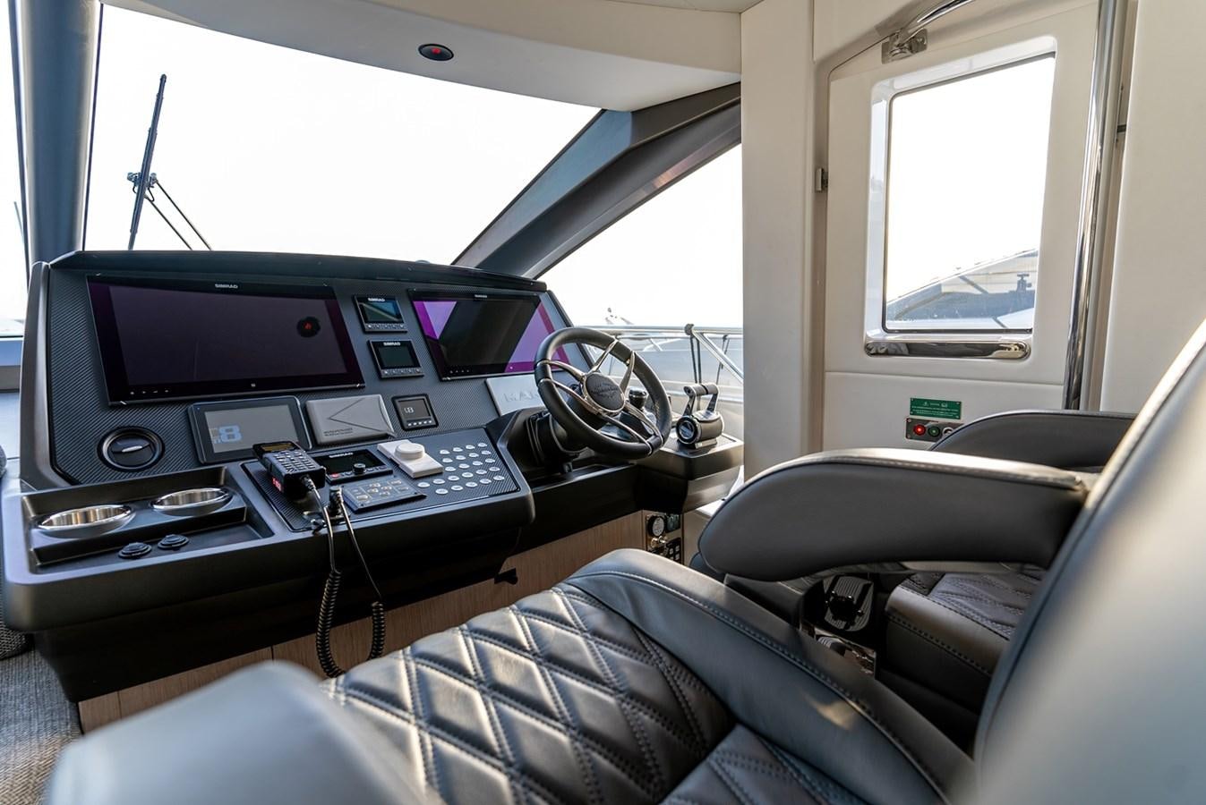 a car with a computer and other electronic devices in it aboard 2023 SUNSEEKER 74 SPORTS  XPS Yacht for Sale