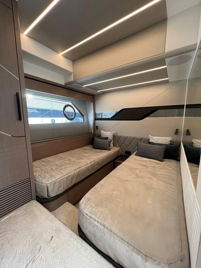 a room with two beds aboard 2023 SUNSEEKER 74 SPORTS  XPS Yacht for Sale