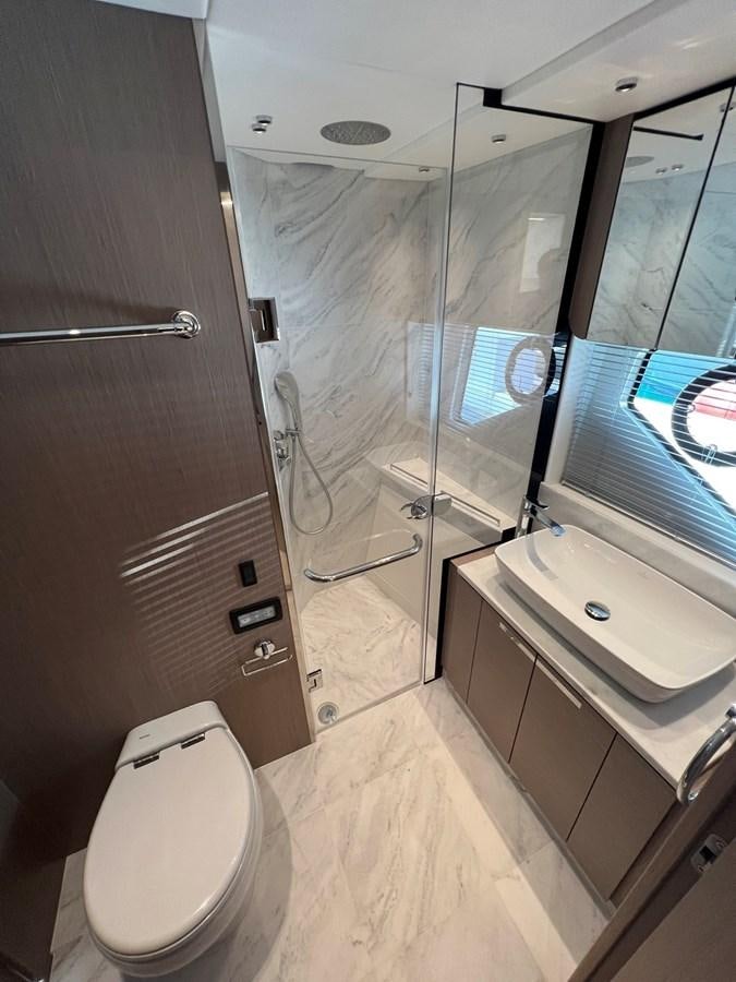 a bathroom with a glass shower aboard 2023 SUNSEEKER 74 SPORTS  XPS Yacht for Sale