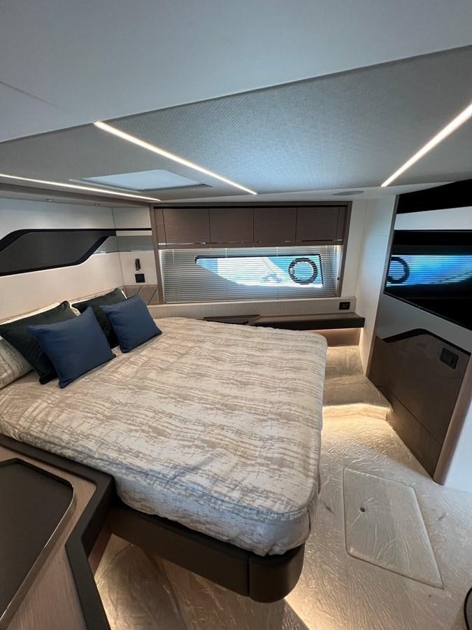 a bed in a room aboard 2023 SUNSEEKER 74 SPORTS  XPS Yacht for Sale