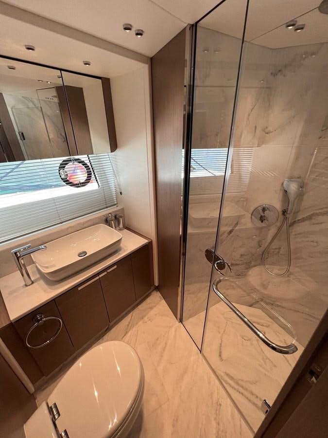 a bathroom with a glass shower aboard 2023 SUNSEEKER 74 SPORTS  XPS Yacht for Sale
