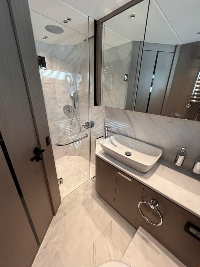 a bathroom with a glass shower aboard 2023 SUNSEEKER 74 SPORTS  XPS Yacht for Sale