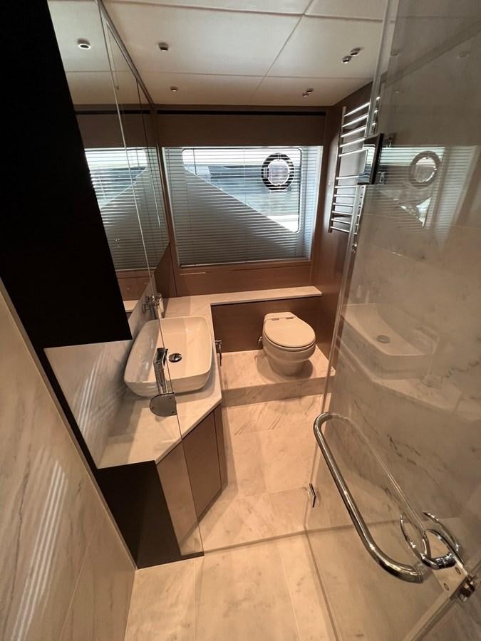 a bathroom with a toilet and a sink aboard 2023 SUNSEEKER 74 SPORTS  XPS Yacht for Sale