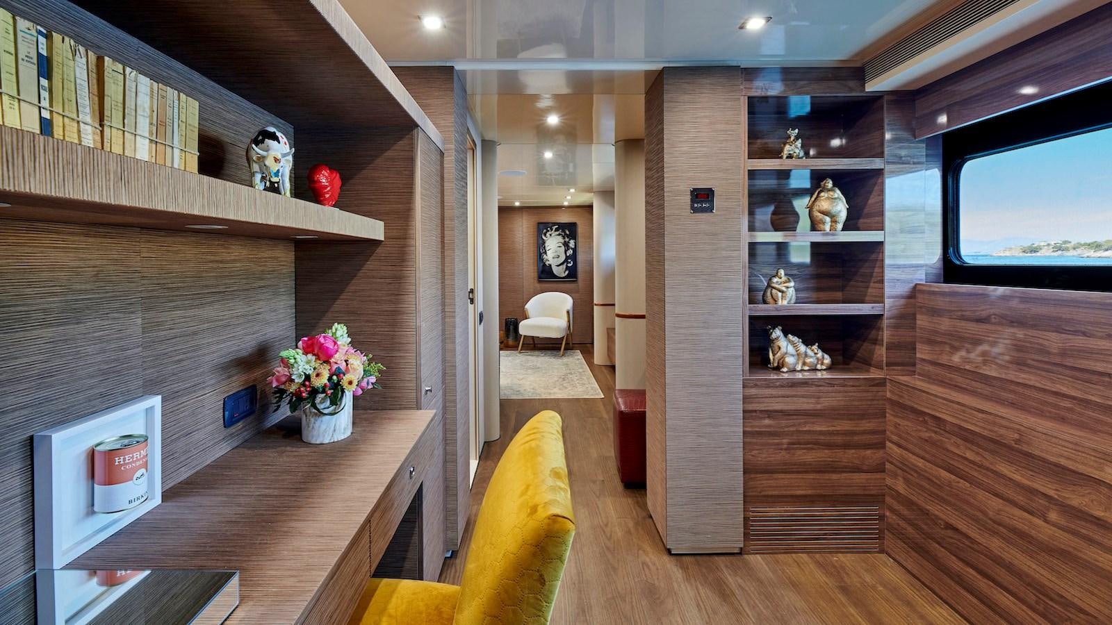 a room with a wood shelf and a shelf with objects on it aboard DALOLI Yacht for Sale