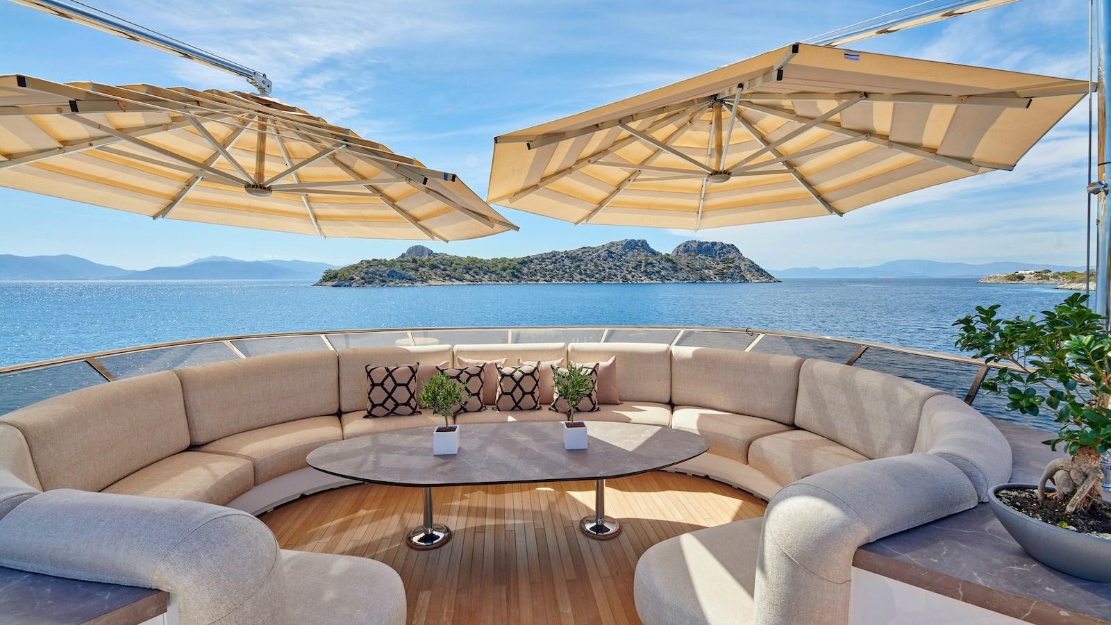 a patio with a table and chairs aboard DALOLI Yacht for Sale