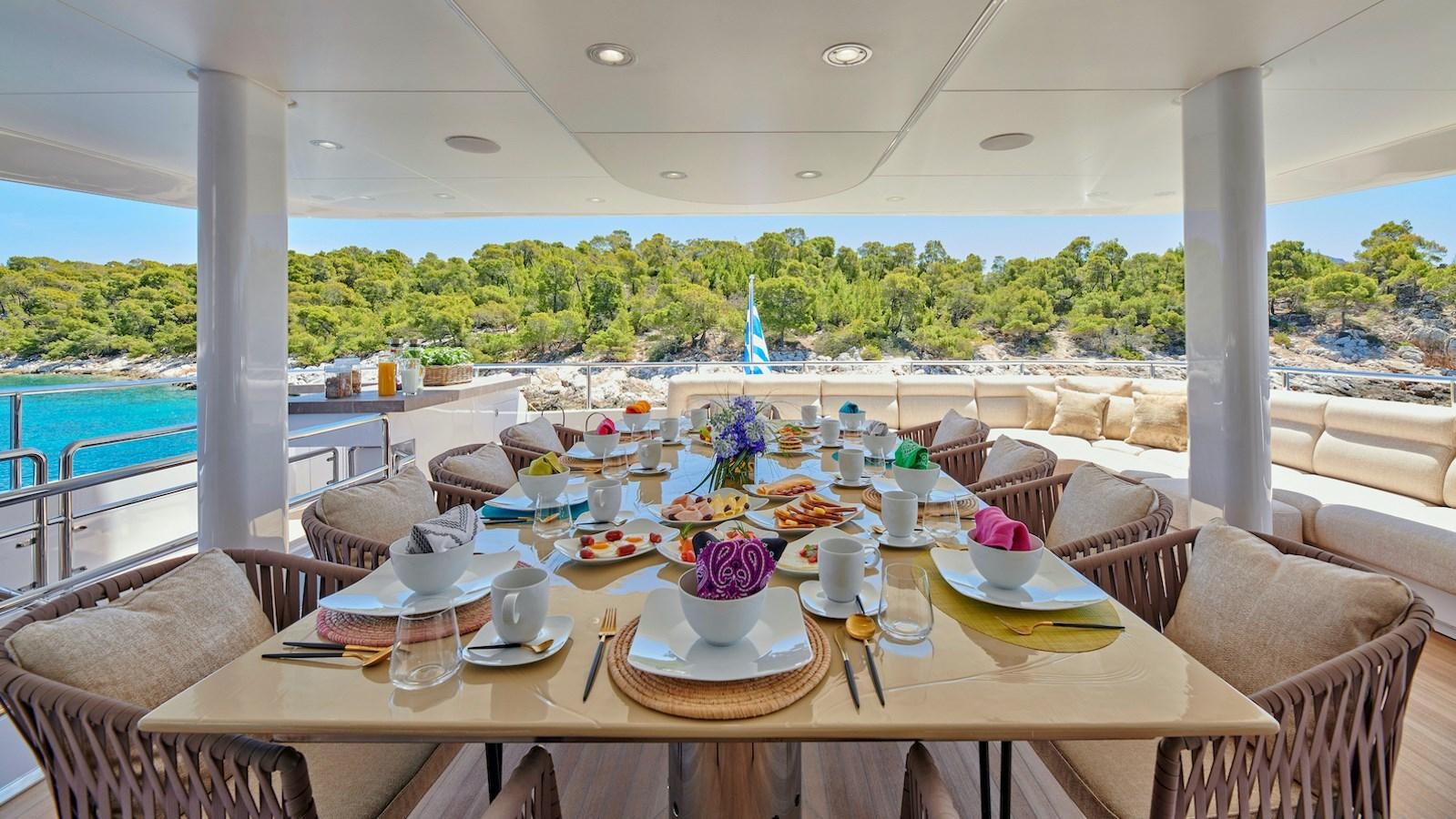 a table with plates and cups on it aboard DALOLI Yacht for Sale