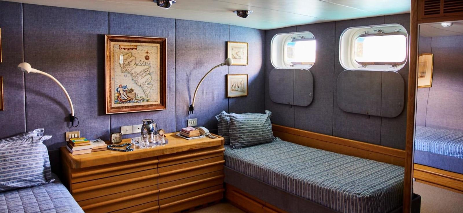 a room with a bed and a desk aboard AETEA Yacht for Sale