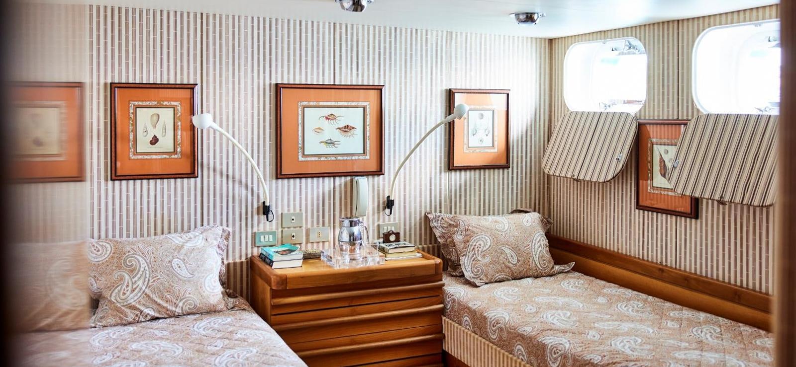 a room with a couple of beds aboard AETEA Yacht for Sale