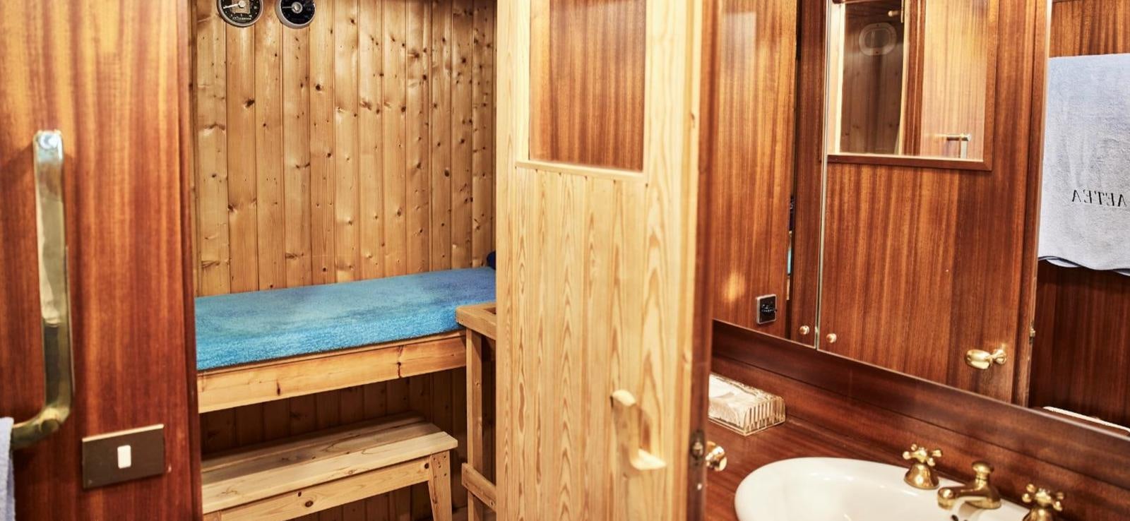 a room with a bed and a sink aboard AETEA Yacht for Sale