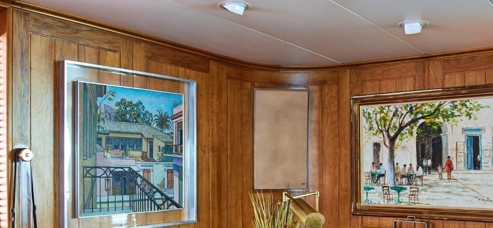a room with a glass door and a glass wall with a painting on it aboard AETEA Yacht for Sale
