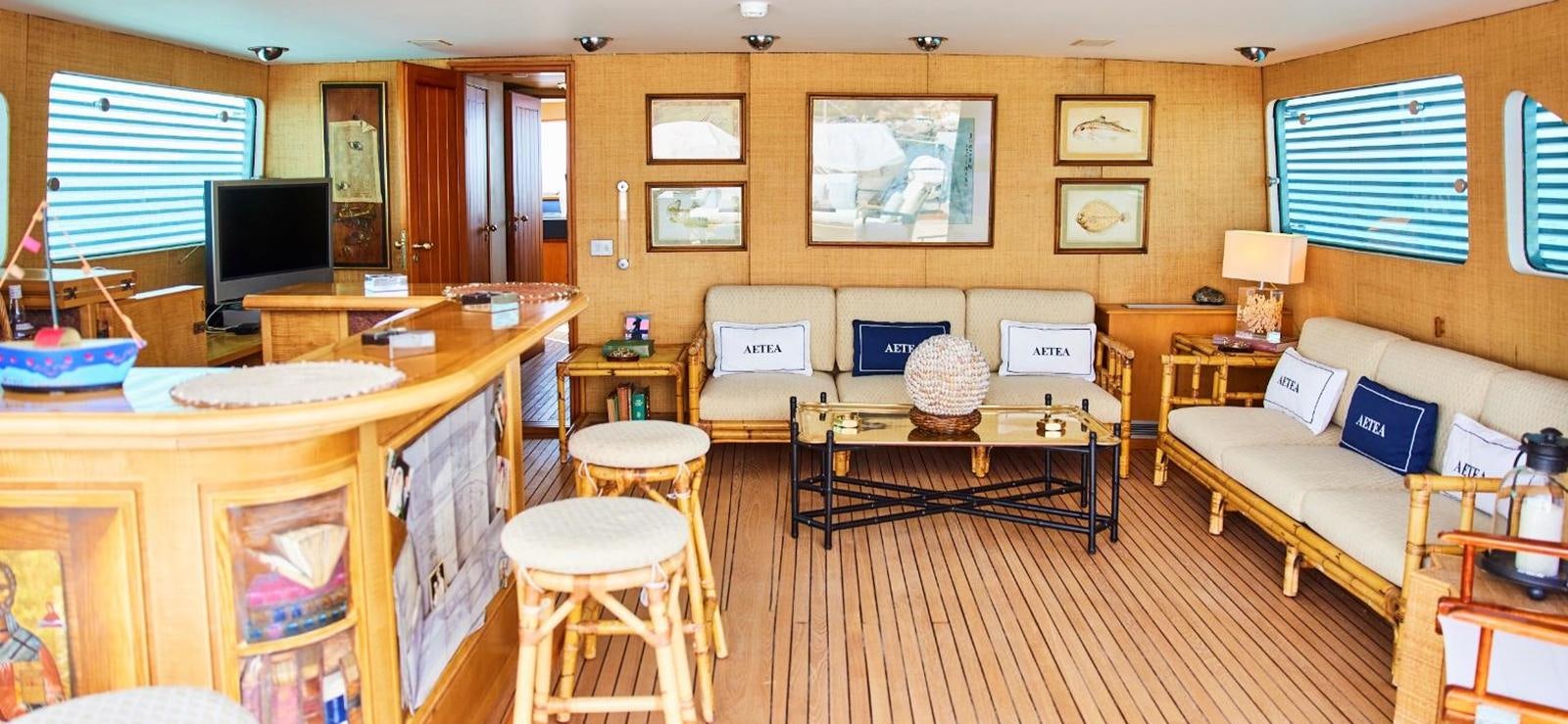 a living room with a couch and a television aboard AETEA Yacht for Sale