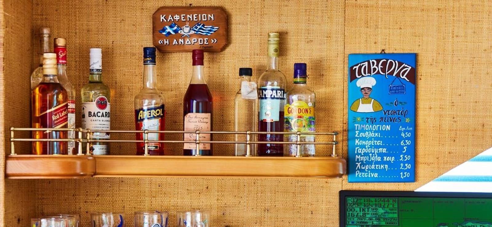 a shelf with bottles of alcohol aboard AETEA Yacht for Sale