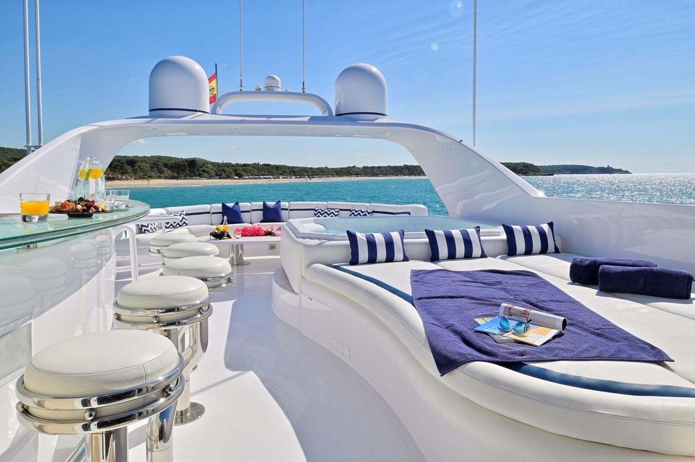 a pool with a table and chairs aboard MOONRAKER Yacht for Sale