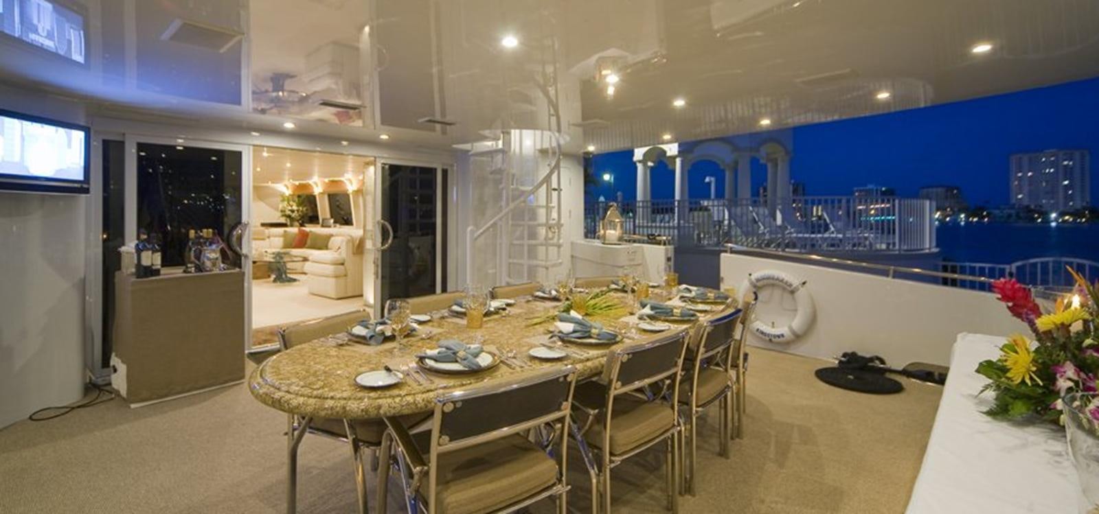 a large room with a table and chairs aboard MOONRAKER Yacht for Sale