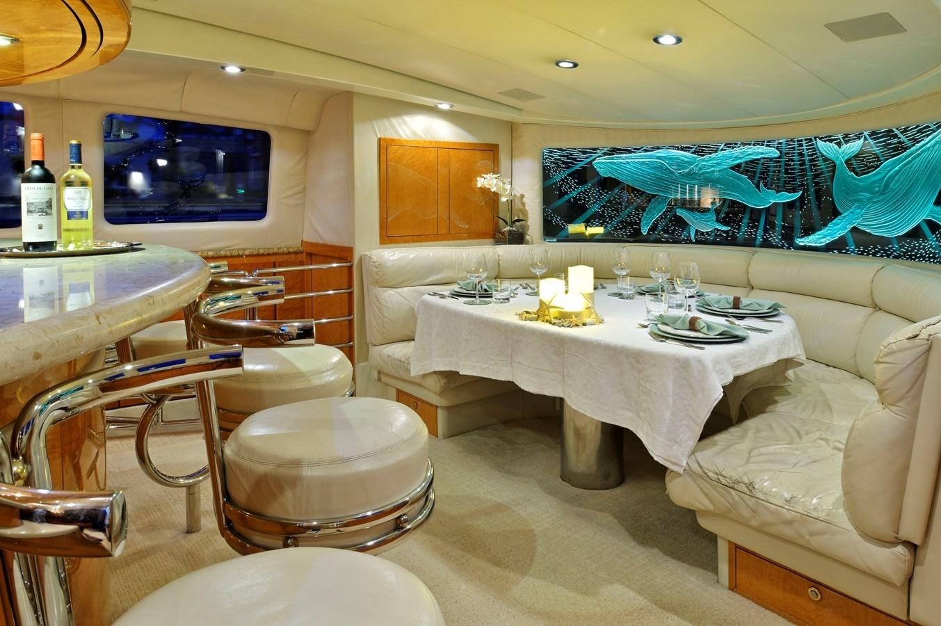 a room with a table and chairs aboard MOONRAKER Yacht for Sale