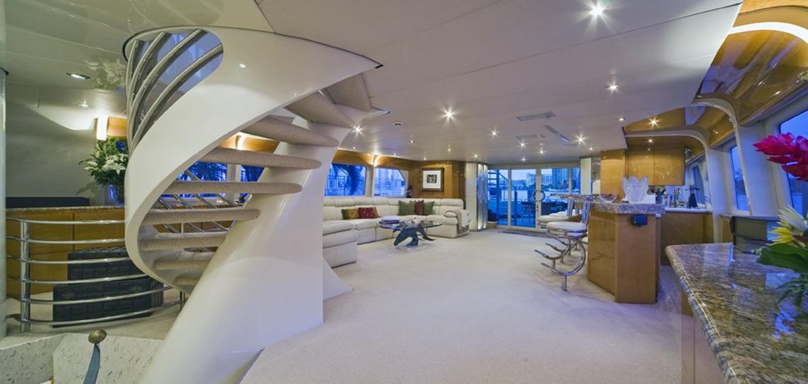 a large white room with a large staircase and glass doors aboard MOONRAKER Yacht for Sale