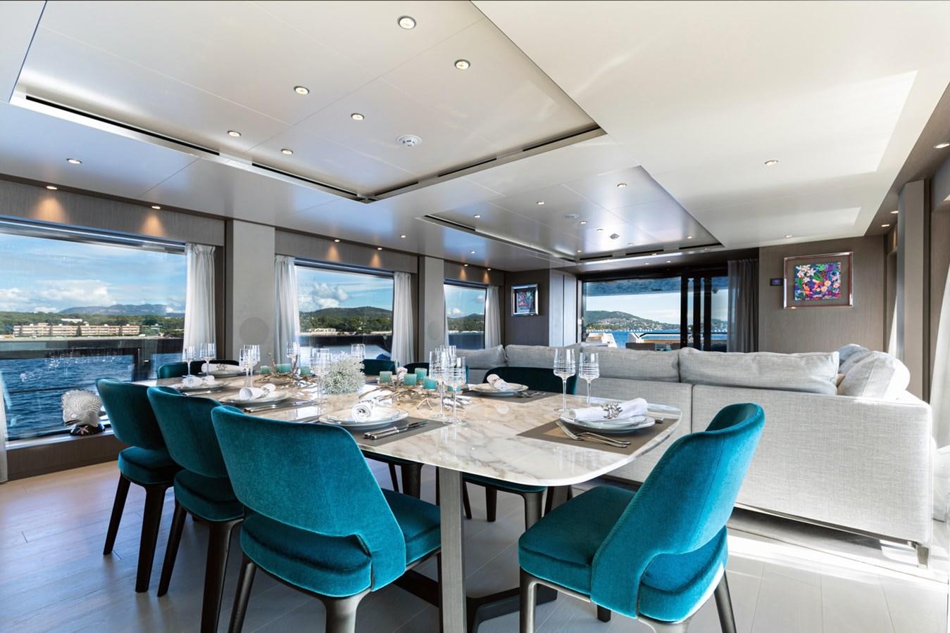a large dining table in a room aboard JAG'B Yacht for Sale