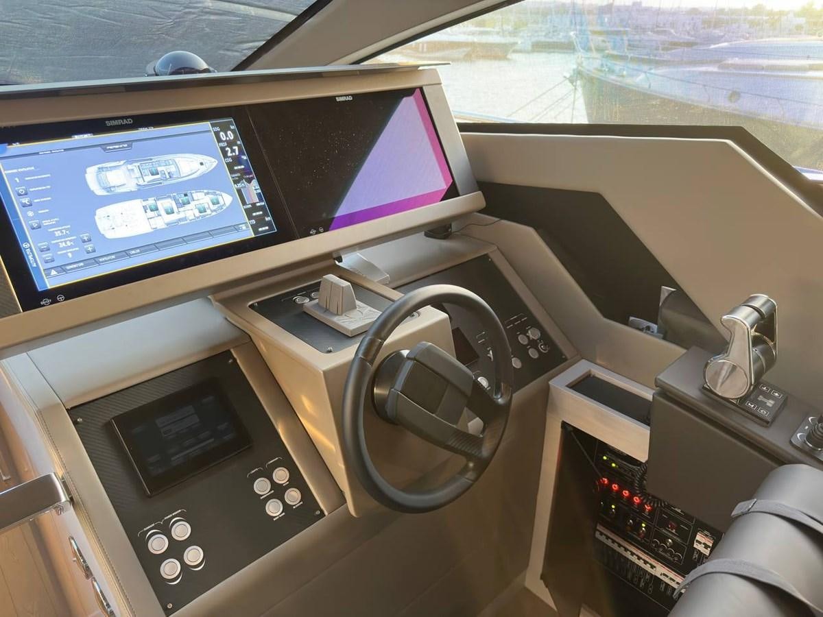 a desk with a computer and a television aboard SAAM 1 Yacht for Sale