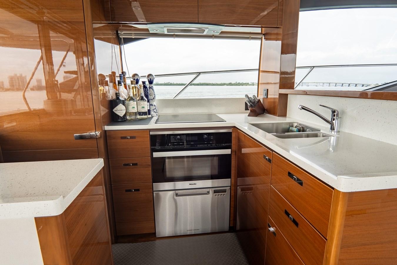 a kitchen with wooden cabinets aboard CINDERELLA Yacht for Sale
