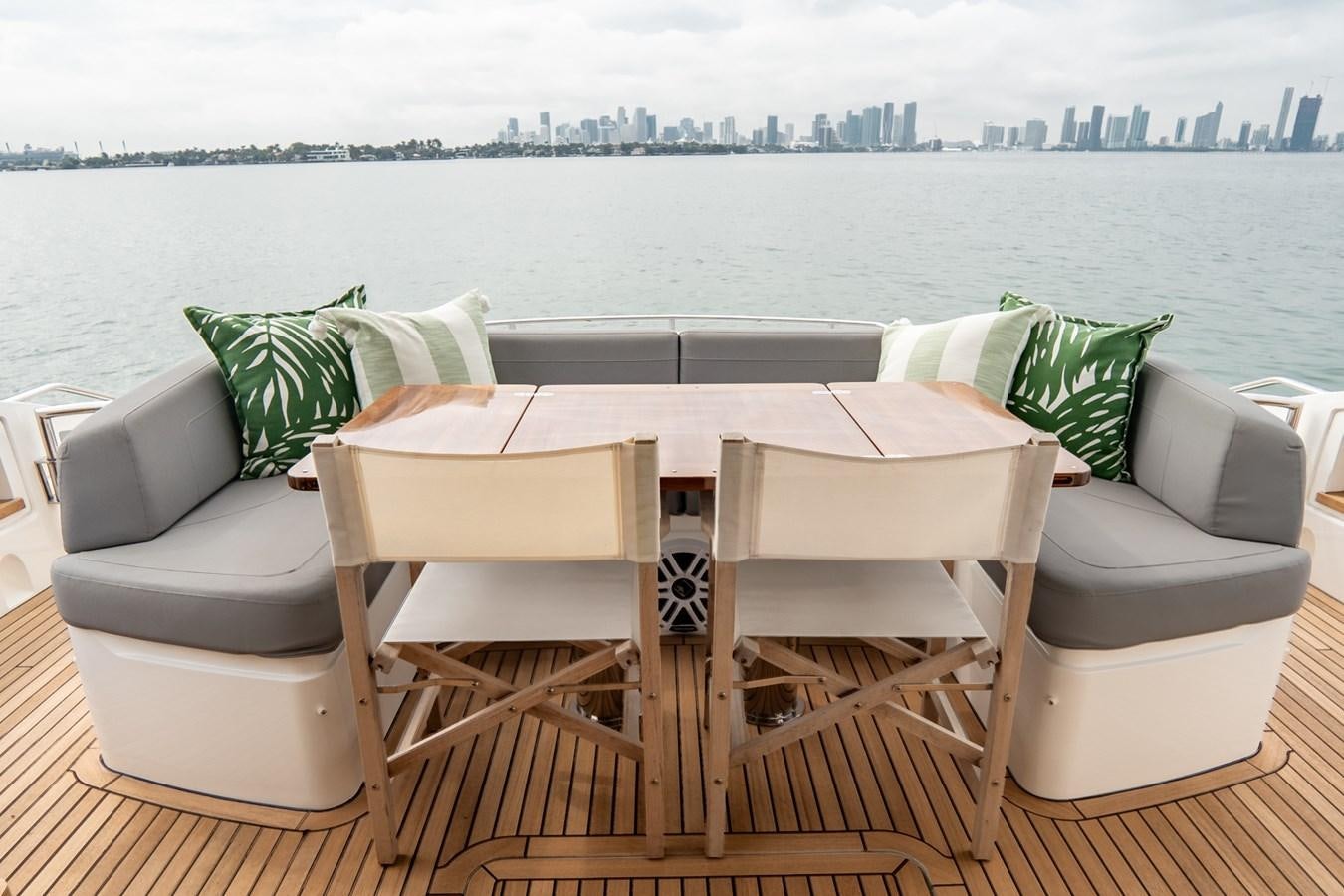 a table and chairs on a deck overlooking a city aboard CINDERELLA Yacht for Sale