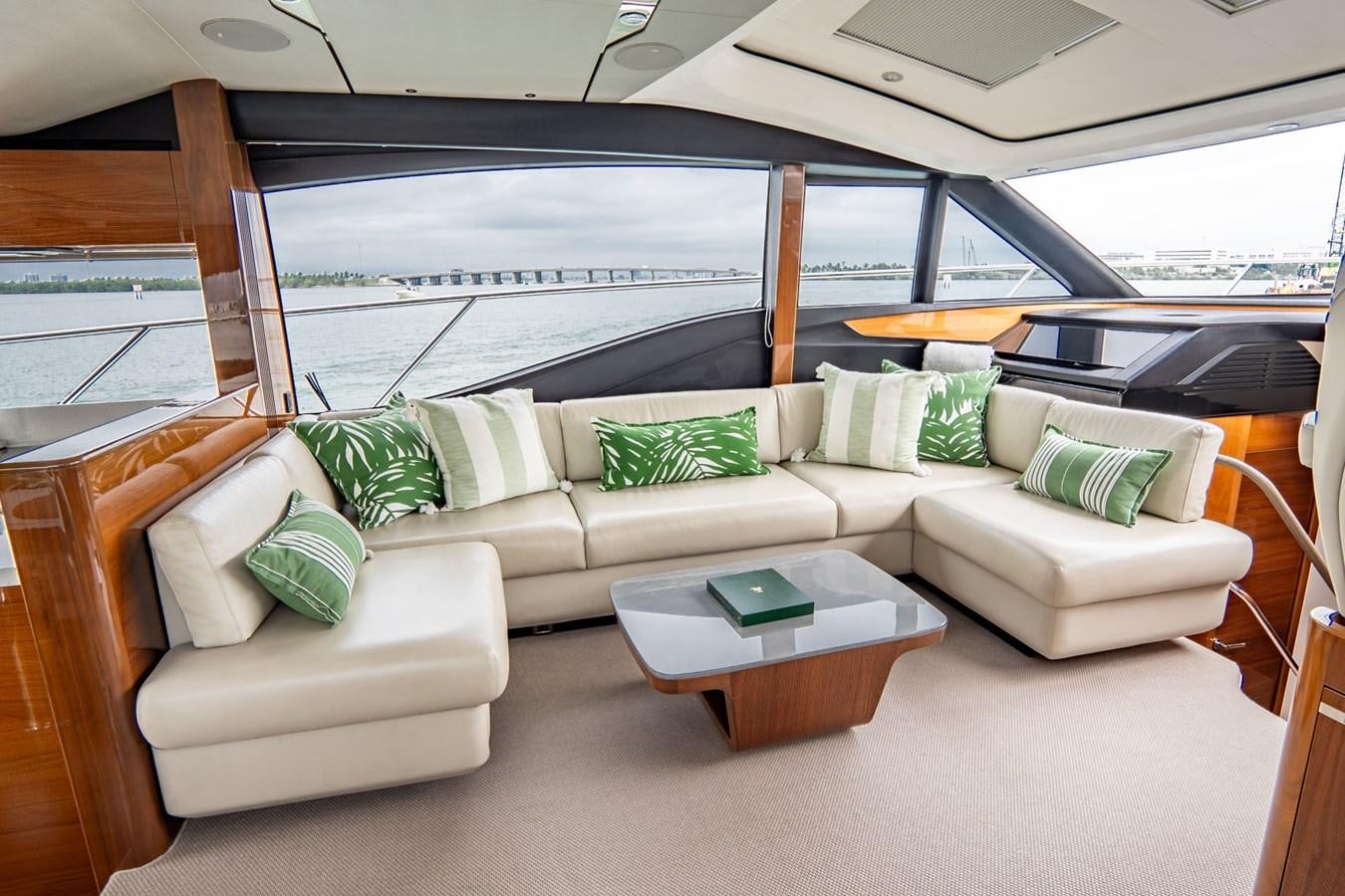 a living room with a couch and a large window aboard CINDERELLA Yacht for Sale