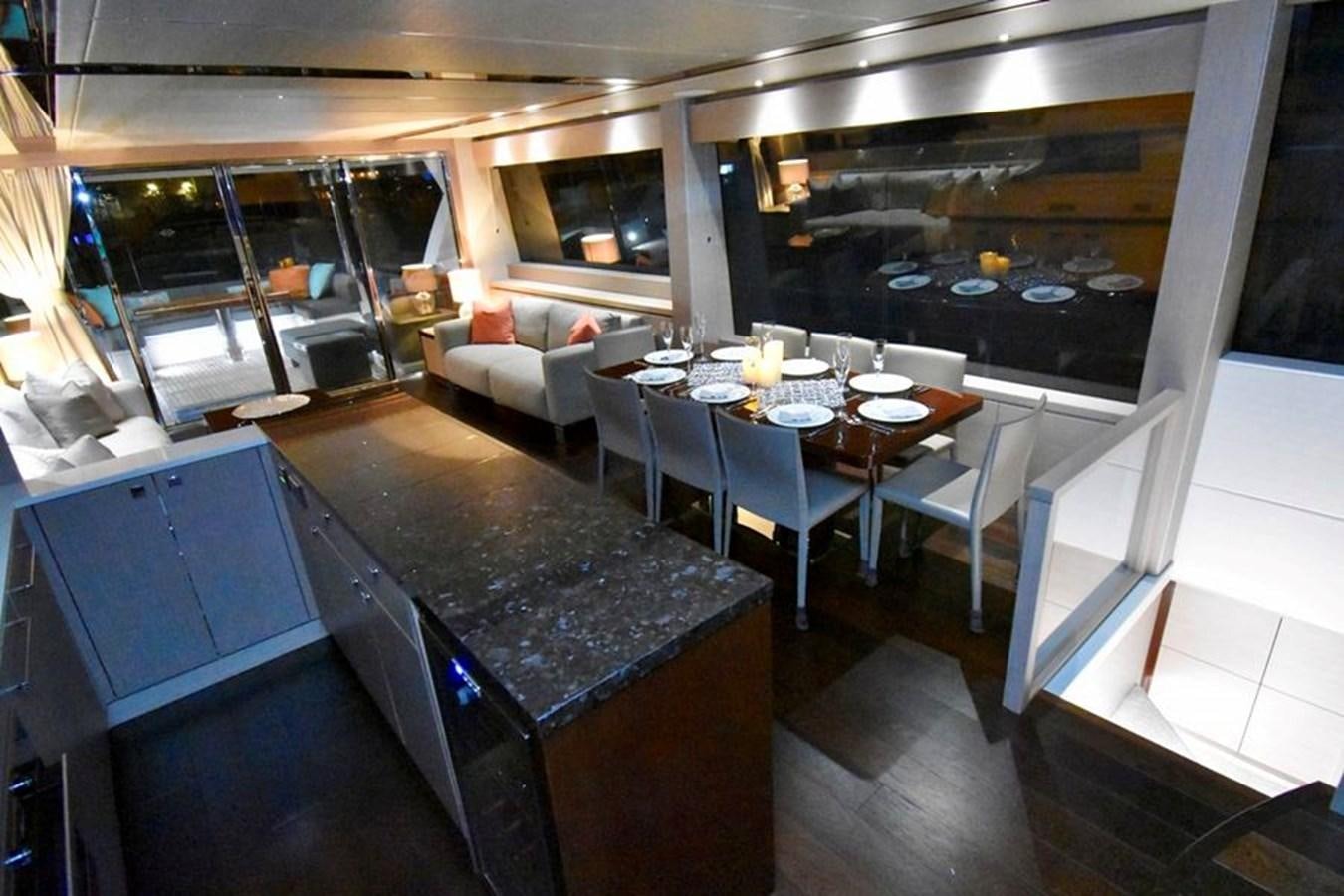 a large kitchen with a bar and dining area aboard DO  ANYWAY Yacht for Sale