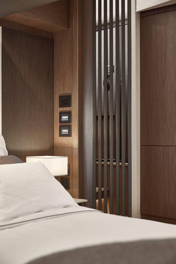 a bed next to a door aboard 2024 PRESTIGE X-LINE X70 Yacht for Sale