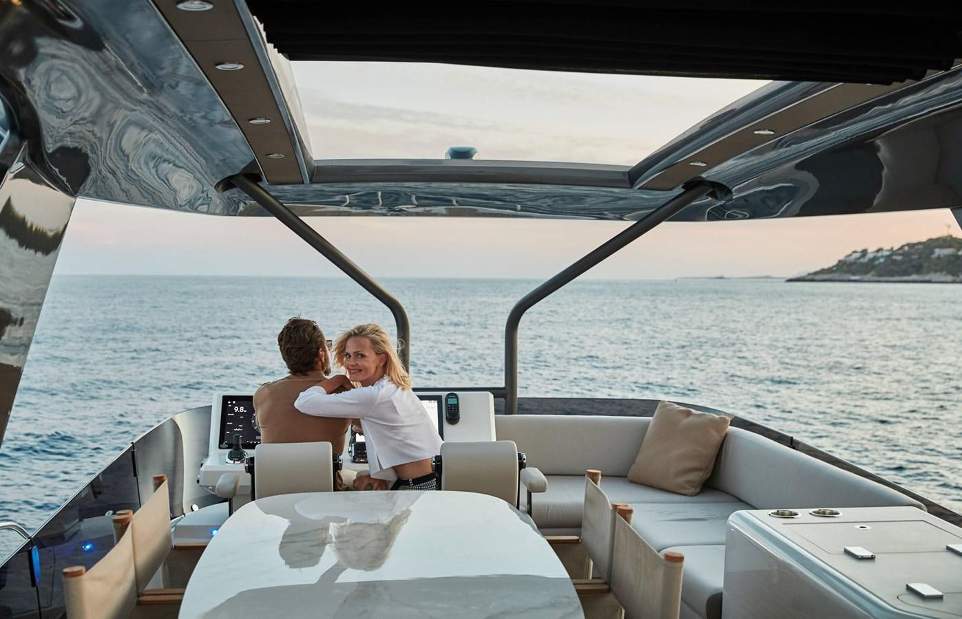 a couple sitting on a boat aboard 2024 PRESTIGE X-LINE X70 Yacht for Sale