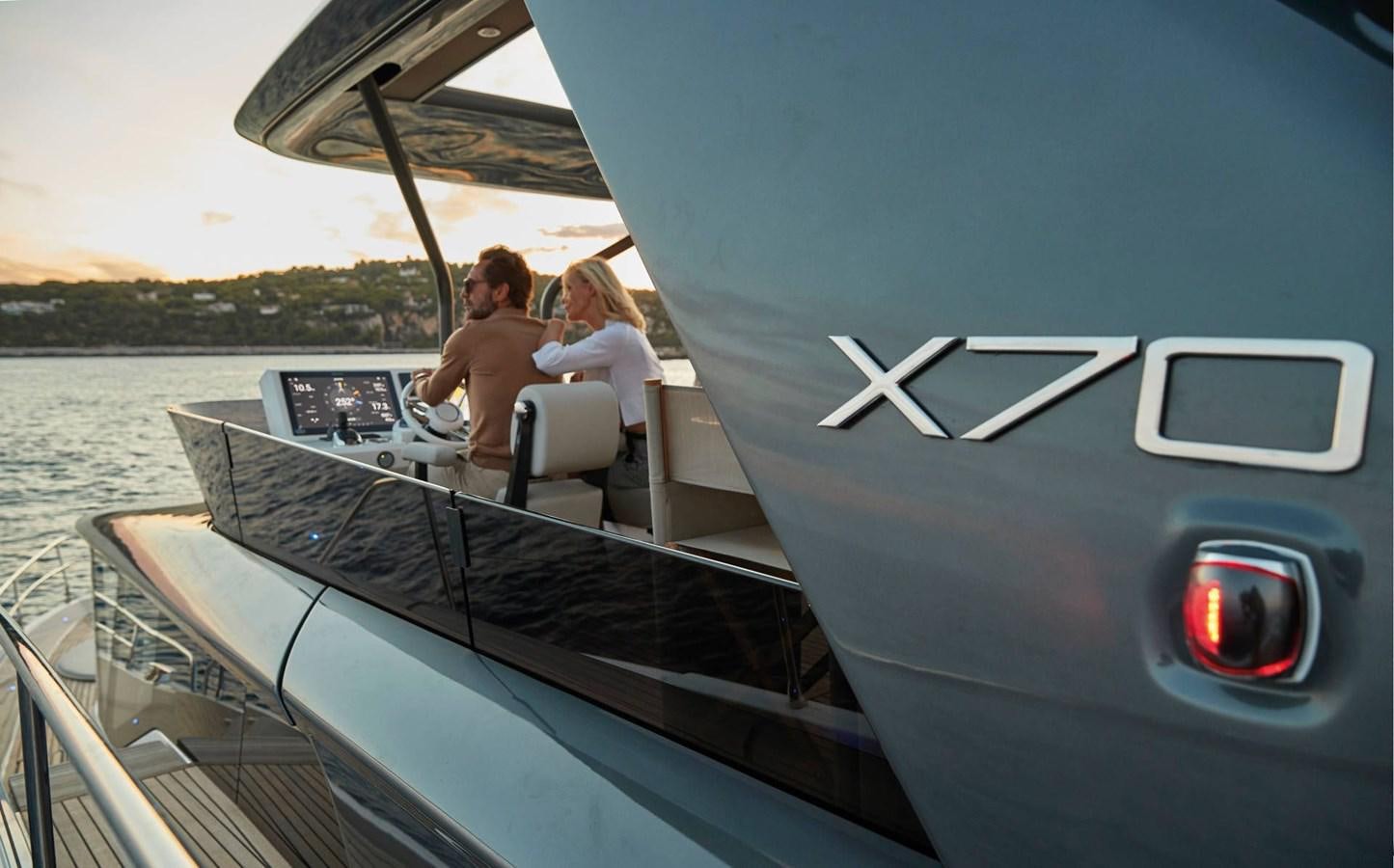 a man and woman sitting on a boat in the water aboard 2024 PRESTIGE X-LINE X70 Yacht for Sale
