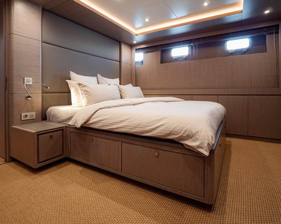 a bed with white sheets aboard HELIAD III Yacht for Sale