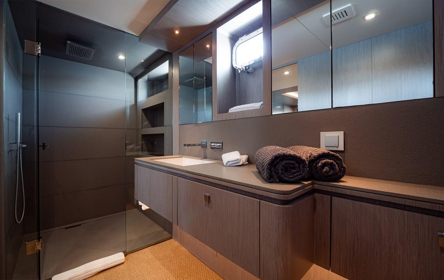 a bathroom with a large mirror aboard HELIAD III Yacht for Sale