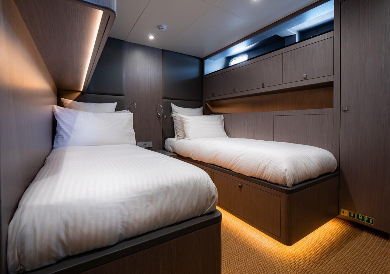 a room with two beds aboard HELIAD III Yacht for Sale