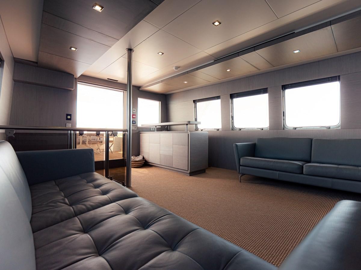 a living room with a couch and a window aboard HELIAD III Yacht for Sale