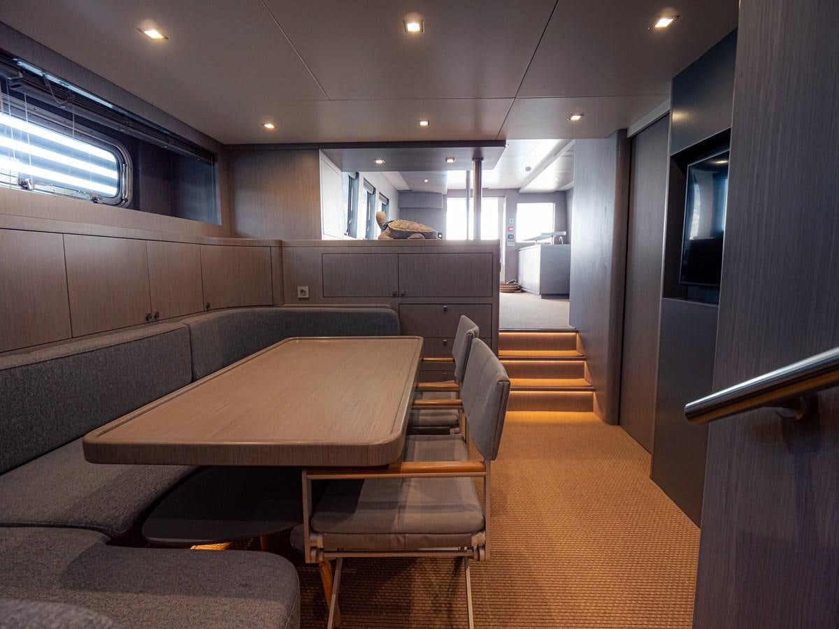 a room with a table and chairs aboard HELIAD III Yacht for Sale