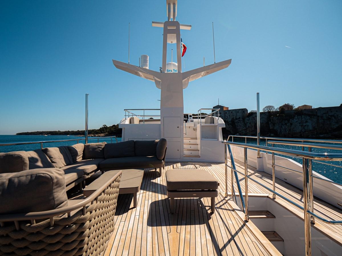 a deck with a large white cross on it and chairs on it aboard HELIAD III Yacht for Sale