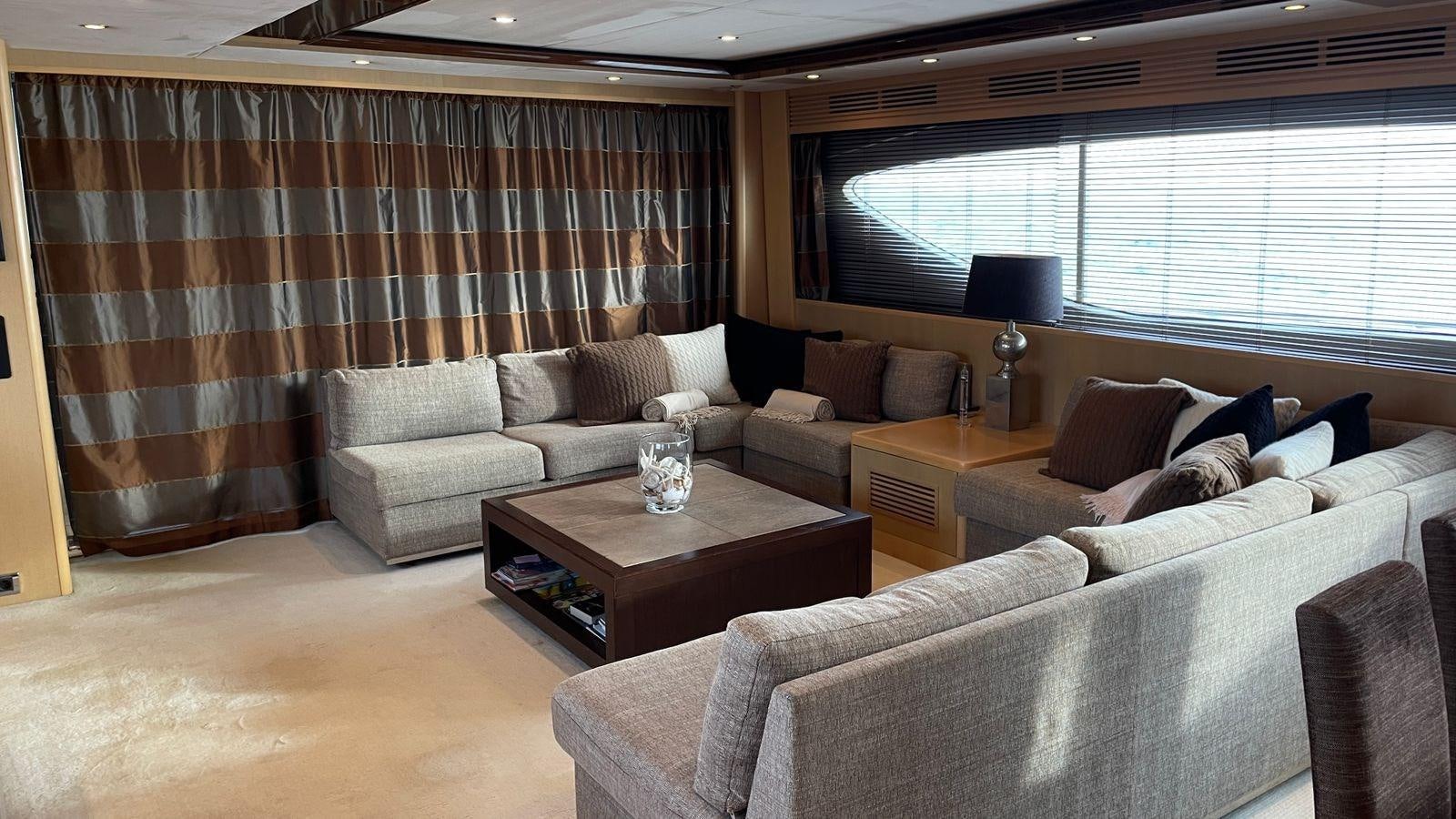 a living room with a couch and a coffee table aboard PRINCESS 21M Yacht for Sale