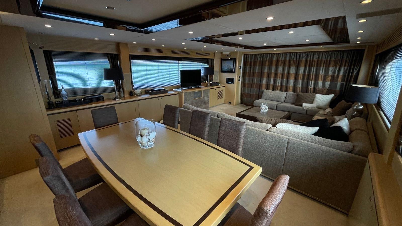 a room with a couch and a table and a tv aboard PRINCESS 21M Yacht for Sale