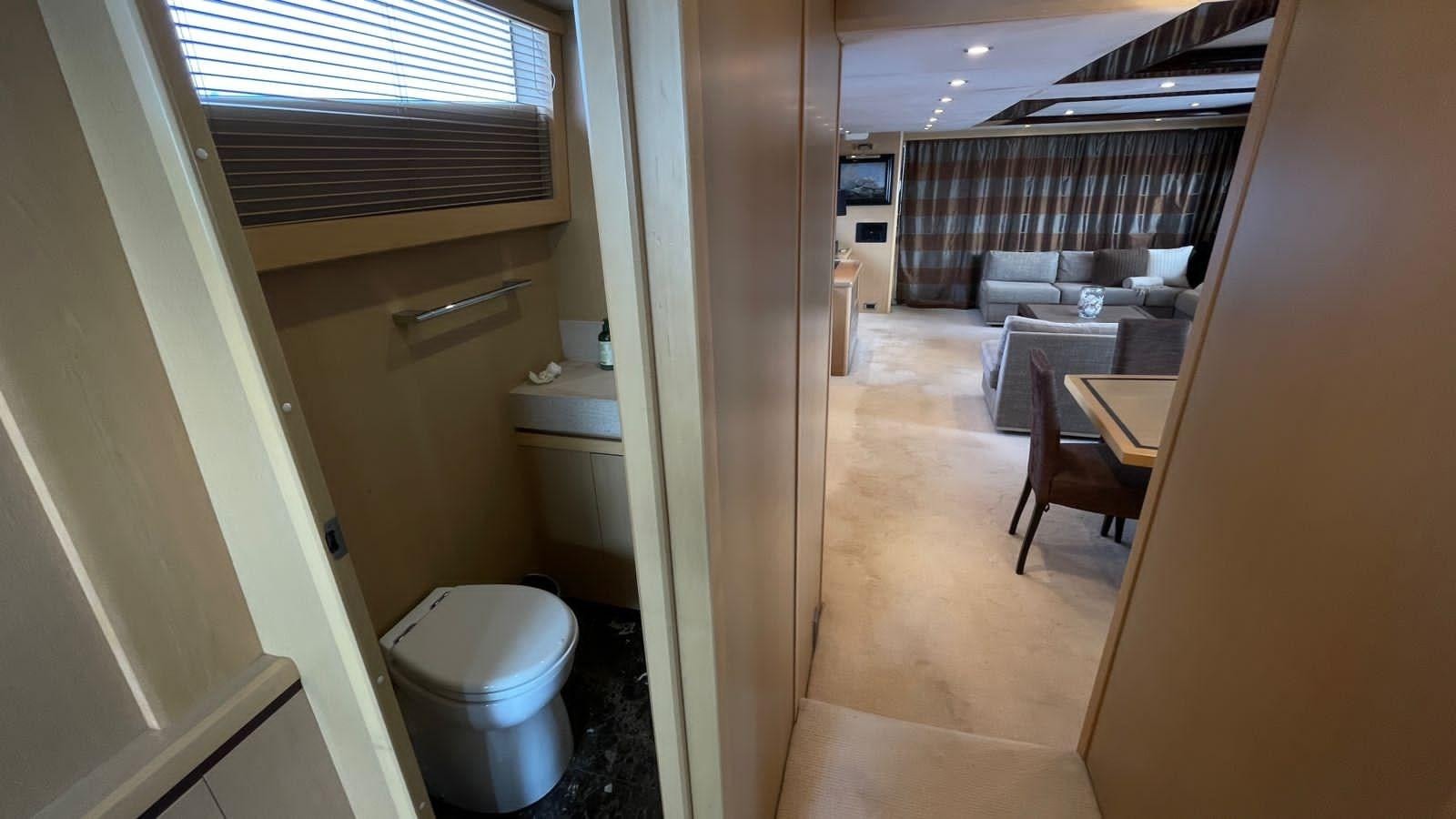a bathroom with a toilet and a sink aboard PRINCESS 21M Yacht for Sale